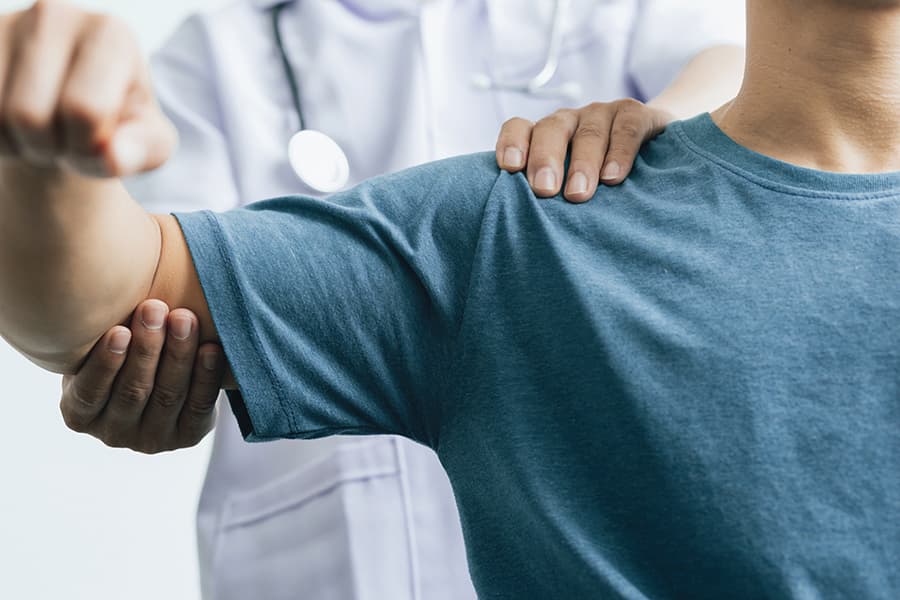 Doctor examining patient's shoulder