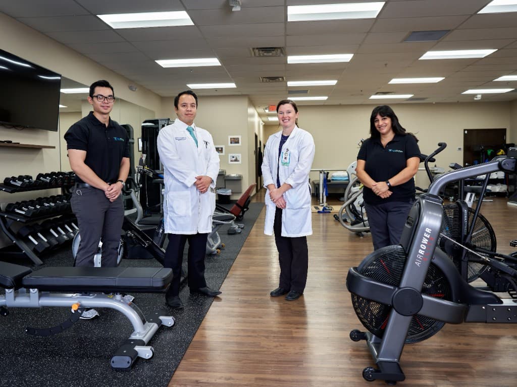The Excel PM&R physician and physical therapy care team in the clinic gym