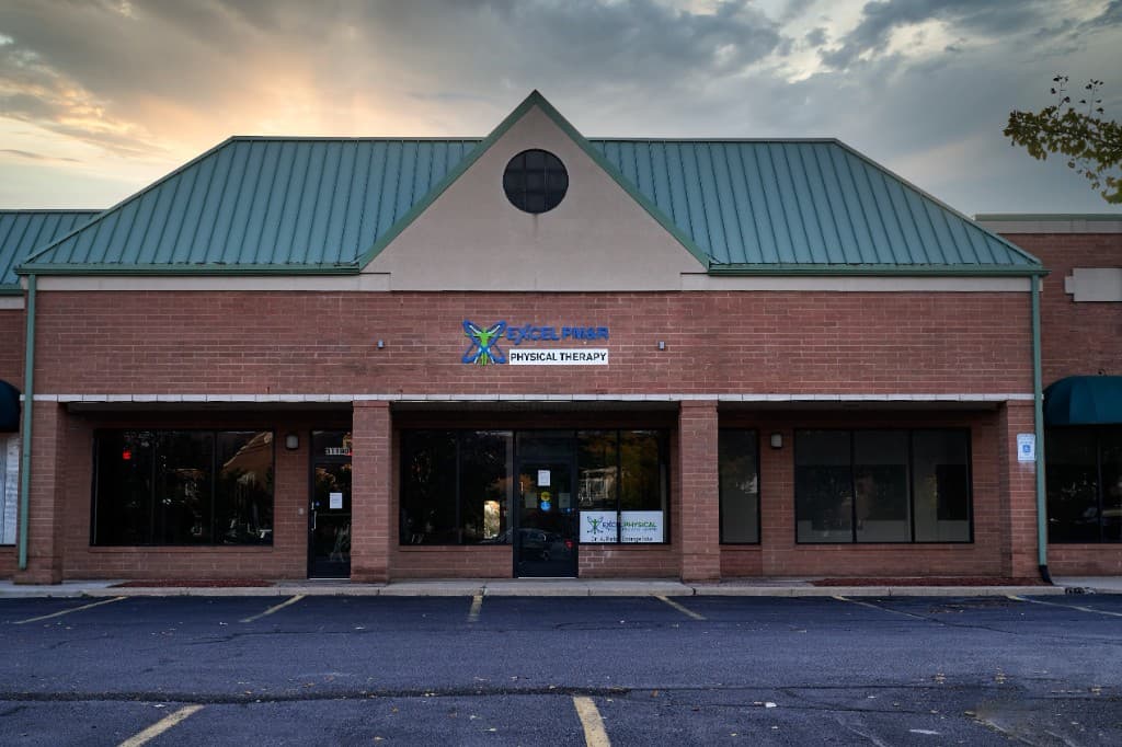Exterior of the Excel PM&R Physical Therapy building in Novi at dusk